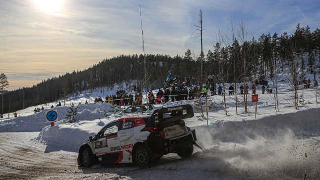 A photo of a rally car racing through the snow in Finland. 