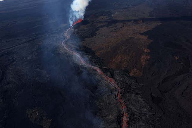 Lava flows from a fissure of Mauna Loa Volcano as it erupts on December 05, 2022 in Hilo, Hawaii.