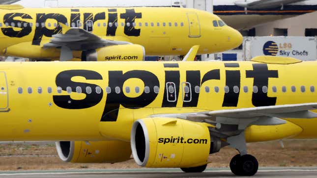 A Spirit Airlines plane flies near another Spirit aircraft at Los Angeles International Airport (LAX) on June 1, 2023 in Los Angeles, California.  More than 40 percent of Spirit Airlines flights around the country were delayed today following technical issues with the airline's app, website and airport kiosks.