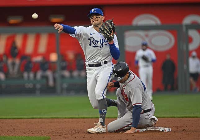 Apr 15, 2023; Kansas City, Missouri, USA;  Kansas City Royals second baseman Michael Massey (19) throws to first base for a double play over Atlanta Braves second baseman Ozzie Albies (1) during the third inning at Kauffman Stadium.
