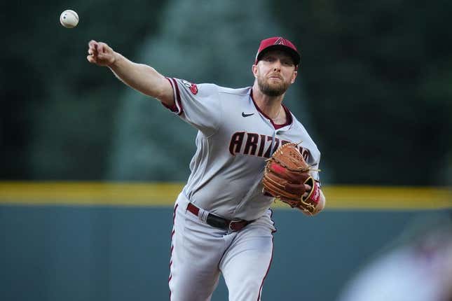 Aug 14, 2023; Denver, Colorado, USA; Arizona Diamondbacks starting pitcher Merrill Kelly (29) delivers a pitch in the first inning against the Colorado Rockies at Coors Field.