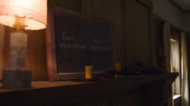 A chalkboard serves as a makeshift memorial for two children in a scene from HBO's The Last of Us.