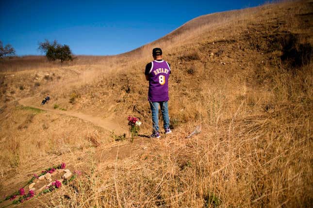  Anthony Calderon leaves flowers to pay his respects at a makeshift memorial on January 26, 2021, in Calabasas, California, at the hillside site of a helicopter crash a year ago that killed nine people, including Lakers basketball player Kobe Bryant and daughter Gianna Bryant.