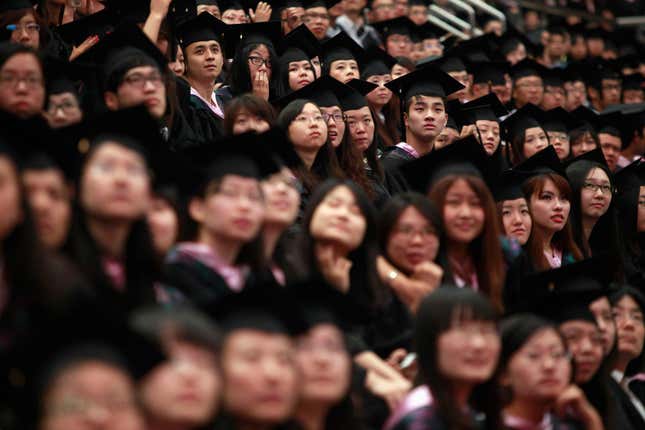 Graduates attend a graduation ceremony at Fudan University in Shanghai