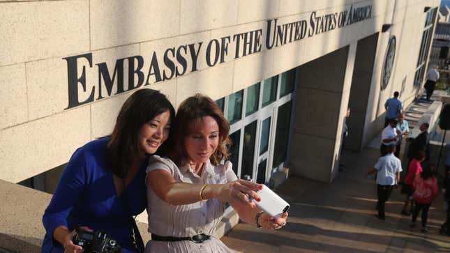 Two women holding cameras take a selfie outside the US. Embassy in Havana, Cuba, a year before the first reports of alleged Havana syndrome.