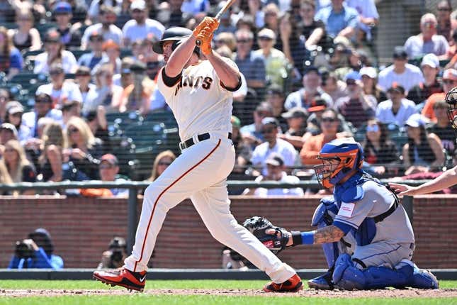 Apr 22, 2023; San Francisco, California, USA; San Francisco Giants designated hitter Darin Ruf (18) hits an RBI single against New York Mets starting pitcher David Peterson (23) during the second inning at Oracle Park.