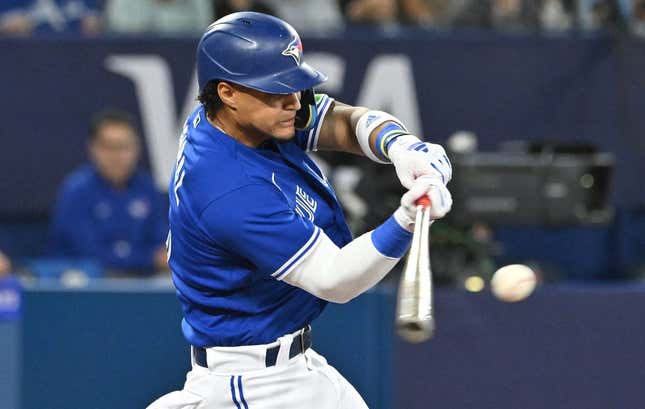 Aug 26, 2023; Toronto, Ontario, CAN;  Toronto Blue Jays shortstop Santiago Espinal (5) hits an RBI double against the Cleveland Guardians in the fourth inning at Rogers Centre.