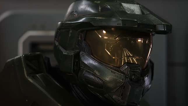 The Master Chief, clad in his iconic green and gold-visored MJLONIR armor, looks towards someone.