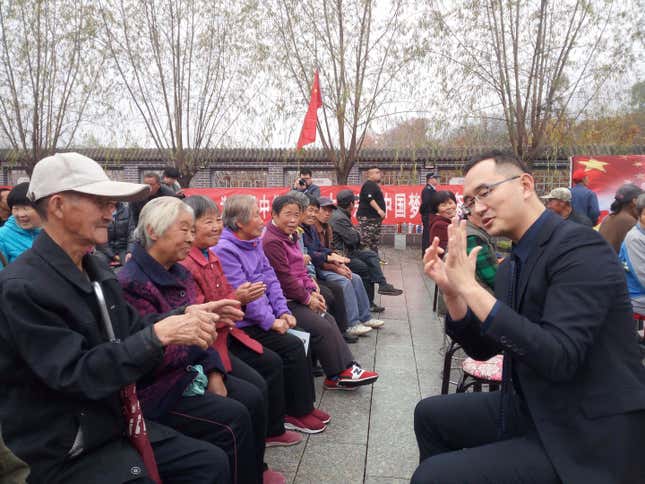 Jason Zhang leads a group in a traditional hand massage during last year’s Double Ninth festival, which celebrates the elderly.