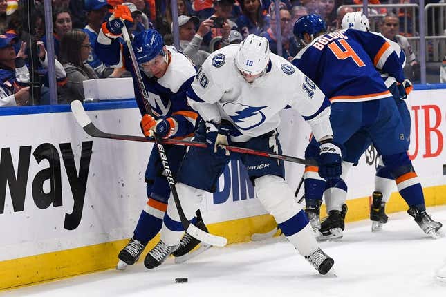 Apr 6, 2023; Elmont, New York, USA; Tampa Bay Lightning right wing Corey Perry (10) and New York Islanders center Casey Cizikas (53) battle for a loose puck during the first period at UBS Arena.