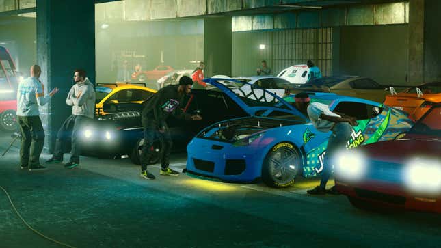 Grand Theft Auto Online characters look over their cars in a musty garage.