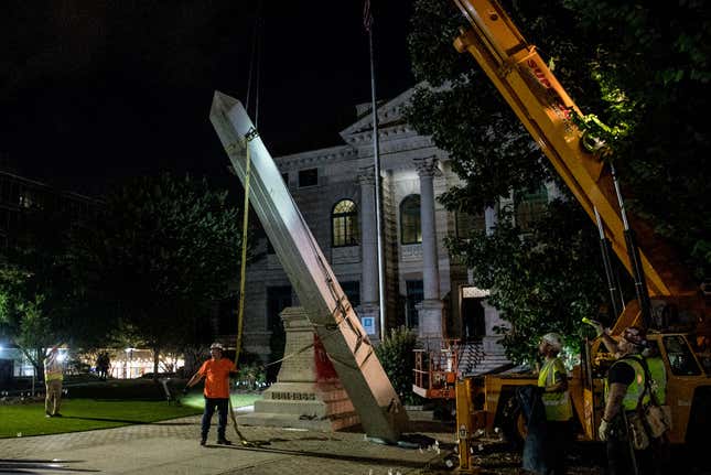 Crew members work to remove the 30-foot Confederate monument which is been brought down on June 19, 2020, in Decatur northeast of Atlanta, Georgia. - Hundreds of people cheered as crews worked to move the Confederate monument from Decatur Square on the eve of Juneteenth. 
