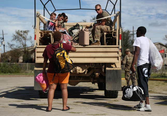 Louisiana National GuardSpc. Jude Urrada prepares to help evacuees onto the truck after Hurricane Laura passed through the area on August 27, 2020, in Lake Charles, Louisiana. 