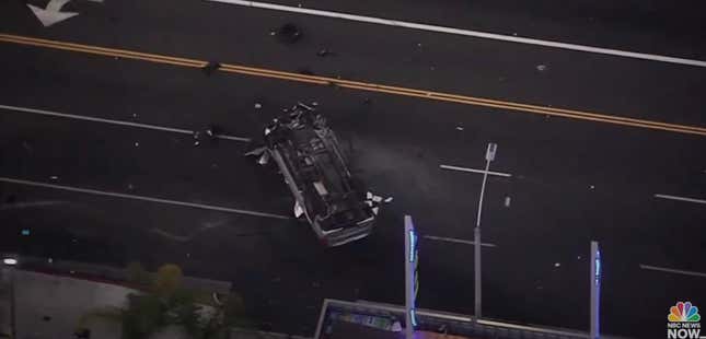 A vehicle upside down, laying across several lanes of traffic just south of Los Angeles downtown area. 
