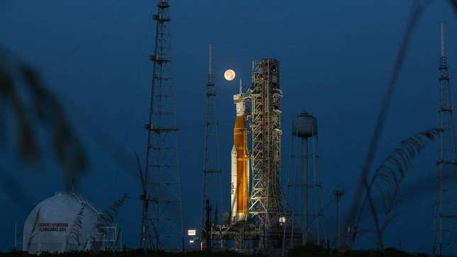 A full Moon is in view from Launch Complex 39B at NASA’s Kennedy Space Center in Florida on June 14, 2022 with the Artemis I Space Launch System (SLS) and Orion spacecraft, atop the mobile launcher.