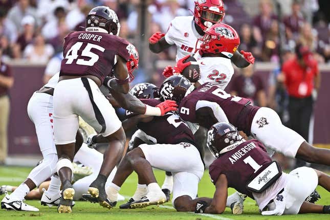 Sep 2, 2023; College Station, Texas, USA; New Mexico Lobos running back Christian Washington (22) is tackled during the second quarter against the Texas A&M Aggies at Kyle Field.