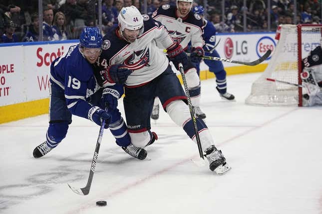 Feb 11, 2023; Toronto, Ontario, CAN; Columbus Blue Jackets defenseman Erik Gudbranson (44) knocks Toronto Maple Leafs forward Calle Jarnkrok (19) off of the puck  during the third period at Scotiabank Arena.