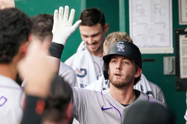 Jun 2, 2023; Kansas City, Missouri, USA; Colorado Rockies third baseman Ryan McMahon (24) is congratulated in the dugout against the Kansas City Royals after his solo home run in the first inning at Kauffman Stadium.