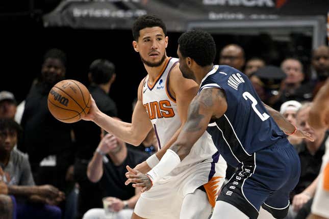 Mar 5, 2023; Dallas, Texas, USA; Phoenix Suns guard Devin Booker (1) and Dallas Mavericks guard Kyrie Irving (2) in action during the game between the Dallas Mavericks and the Phoenix Suns at the American Airlines Center.