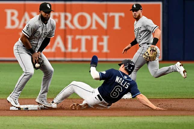 Apr 22, 2023; St. Petersburg, Florida, USA; Tampa Bay Rays third basemanTaylor Walls (0) slides as Chicago White Sox shortstop Elvis Andrus (1) catches the ball in the first inning at Tropicana Field.
