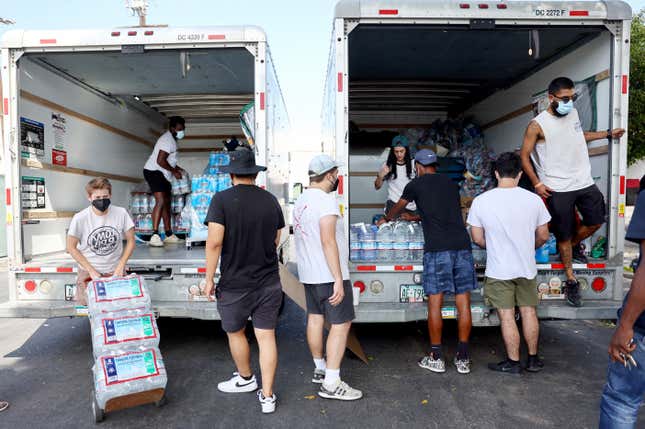 Volunteers with Water Drop LA prepare to deliver water and other items to members of the Skid Row community on September 4, 2022 in Los Angeles, California.