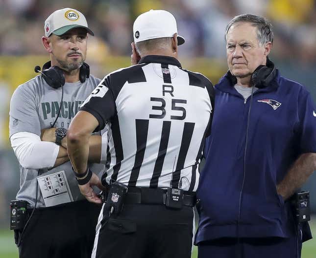 Aug 19, 2023; Green Bay, WI, USA; Green Bay Packers head coach Matt LaFleur and New England Patriots head coach Bill Belichick talk with referee John Hussey (35) during their football game at Lambeau Field. The game was suspended in the fourth quarter following an injury to New England Patriots cornerback Isaiah Bolden (7).