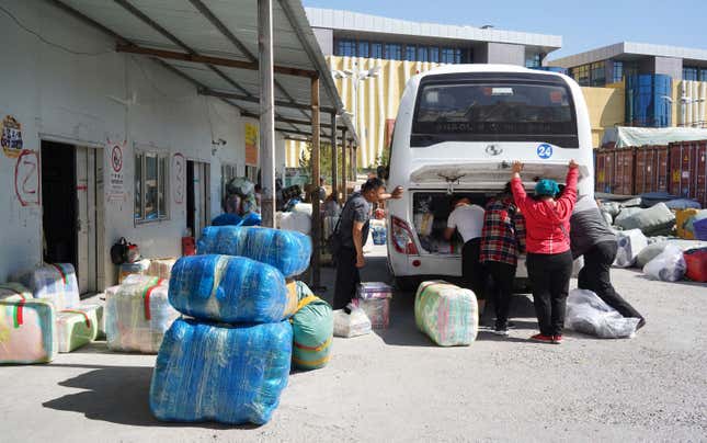 The shoppers stuff their purchases onto the shuttle bus, preparing to leave Khorgos ICBC.