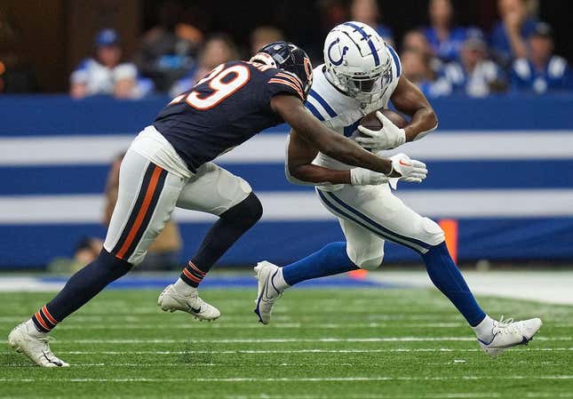 Chicago Bears cornerback Tyrique Stevenson (29) drives Indianapolis Colts running back Kenyan Drake (31) out of bounds with a tackle during the first half of an NFL preseason game Saturday, Aug. 19, 2023, at Lucas Oil Stadium in Indianapolis.