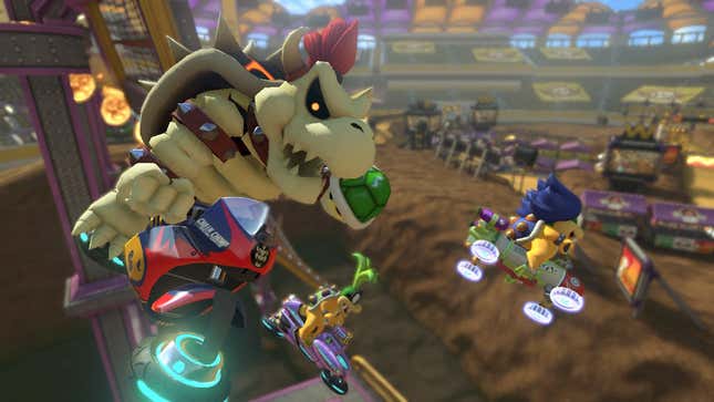 Dry Bowser, a bowser without skin, flies through the air on a motorcyle above a dirtbike track. He holds a green shell in his left hand.