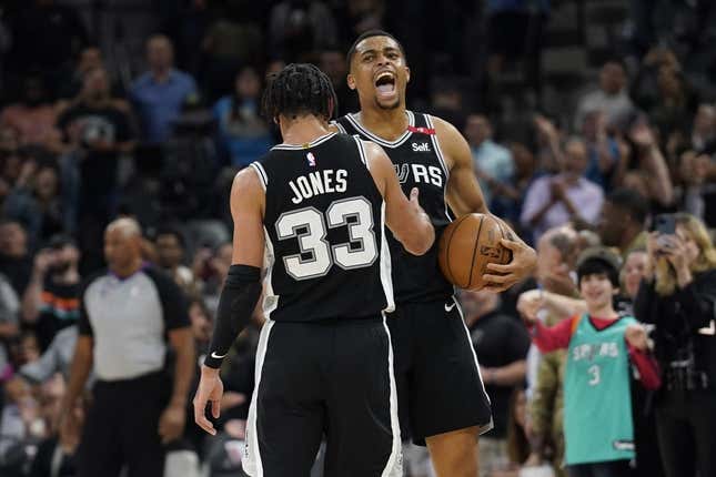 Mar 10, 2023; San Antonio, Texas, USA; San Antonio Spurs forward Keldon Johnson (3) and guard Tre Jones (33) react after a victory over the Denver Nuggets at AT&amp;amp;T Center.