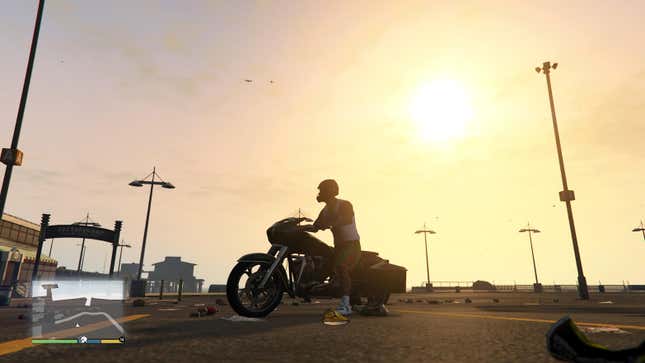 A screenshot of a man on a motorcycle watching the sun set in GTA V on PS5.