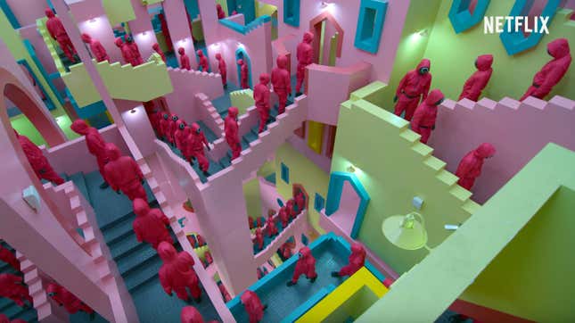 A still from Squid Game shows the guards walking up the staircases. 