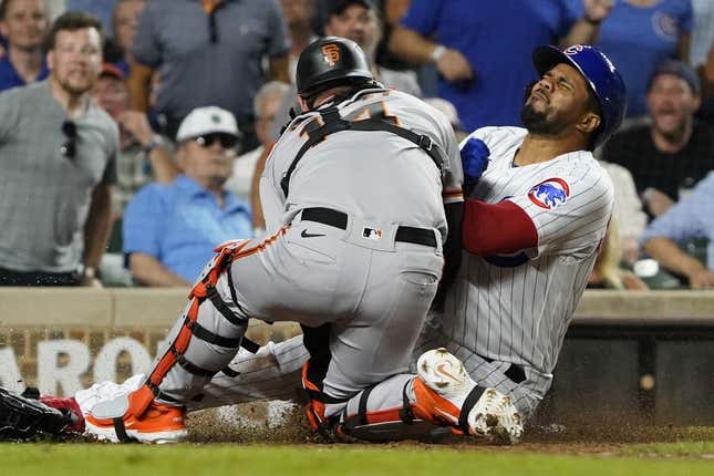 Sep 5, 2023; Chicago, Illinois, USA;Chicago Cubs third baseman Jeimer Candelario (9) is safe at home plate as San Francisco Giants catcher Patrick Bailey (14) can t catch the ball during the seventh inning at Wrigley Field.