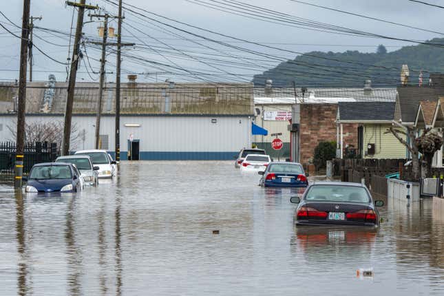 Cars are partially submerged in floodwaters in Watsonville, California, Saturday, March 11, 2023.