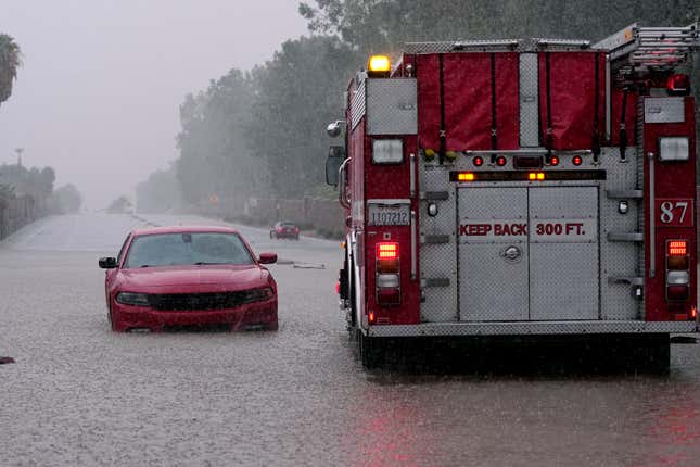 A fire truck pulls away after a motorist became stranded in rising floodwaters caused by torrential rain brought by Tropical Storm Hilary, Sunday, August. 20, 2023, in Palm Desert, California. 