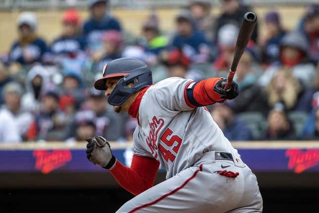 Apr 22, 2023; Minneapolis, Minnesota, USA; Washington Nationals first baseman Joey Meneses (45) hits a RBI ground ball in the first inning against the Minnesota Twins at Target Field.