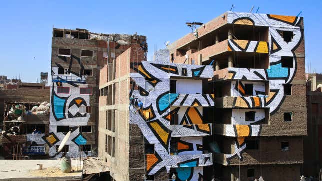 Image for article titled This incredible 50-building-wide street art honors Cairo’s trash pickers