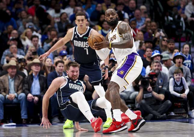Feb 26, 2023; Dallas, Texas, USA; Los Angeles Lakers forward LeBron James (6) looks to pass as Dallas Mavericks guard Luka Doncic (77) defends during the second quarter at American Airlines Center.