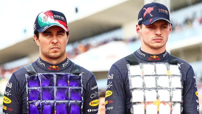Sergio Perez of Mexico and Oracle Red Bull Racing and Max Verstappen of the Netherlands and Oracle Red Bull Racing stand in tribute to the late Dietrich Mateschitz during the F1 Grand Prix of USA at Circuit of The Americas on October 23, 2022 in Austin, Texas
