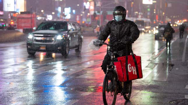 GrubHub delivery person bikes through snow