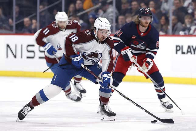 Feb 24, 2023; Winnipeg, Manitoba, CAN; Colorado Avalanche center Alex Newhook (18) skates up the ice past Winnipeg Jets left wing Kyle Connor (81) in the first period at Canada Life Centre.