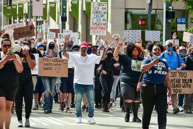 Participants in a march for the Black Lives Matter movement raise their arms as they make their way along the Boulevard of the Allies, Saturday, June 13, 2020, in downtown Pittsburgh.