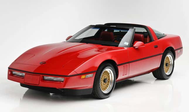 Red 1985 Chevrolet Corvette with gold spindle wheels targa top