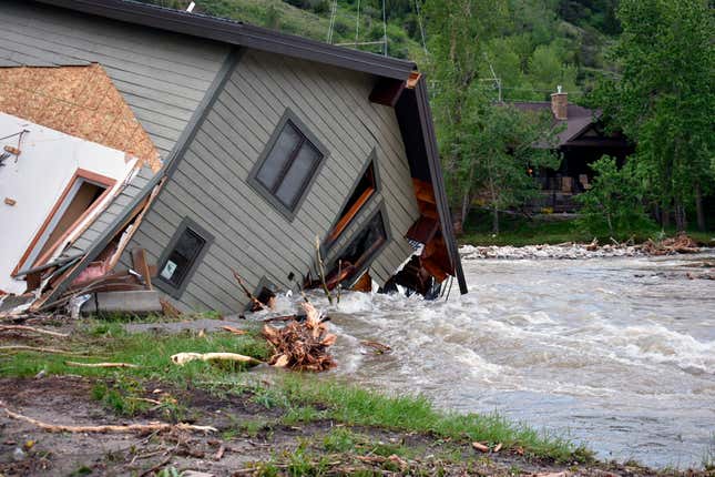 collapsed house in floodwaters