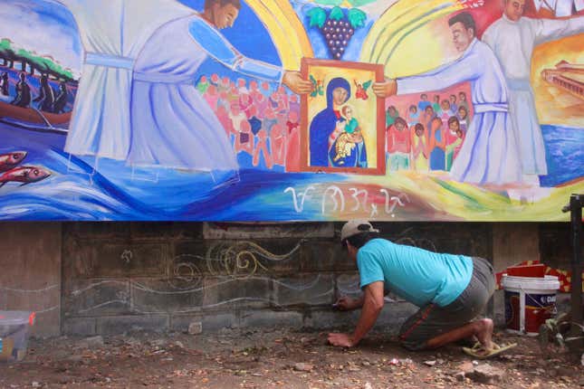 A drug surrenderer works on a mural at the Baclaran as part of the church’s livelihood program to support victims of the drug war.