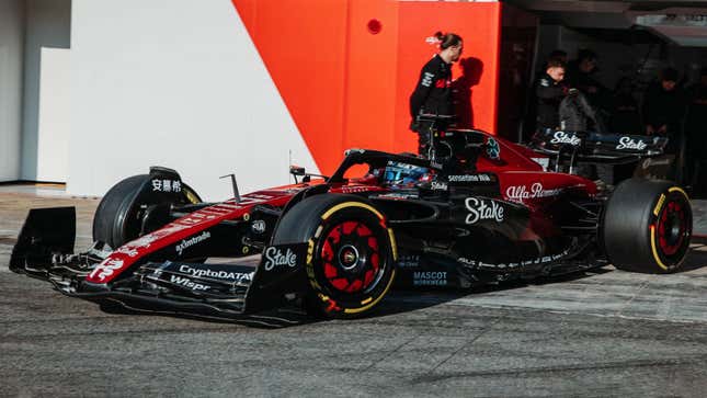 A photo of the red and black 2023 Alfa Romeo F1 car testing. 