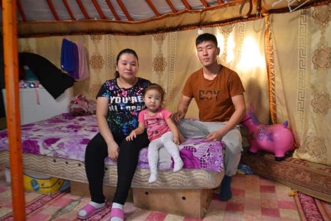 Davaadulam Jangalsaikhen, Sukhbayar Enkhjakfel, and their daughter Sendor Sukhbayar in their home in Ulaanbaatar.