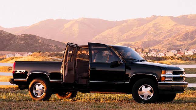 A photo of a Chevrolet pickup truck with its four doors wide open. 
