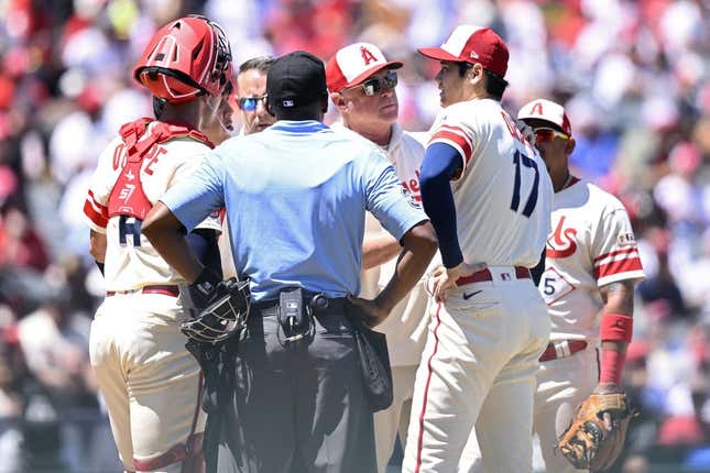 Aug 23, 2023; Anaheim, California, USA; Los Angeles Angels manager Phil Nevin (center) meets with starting pitcher Shohei Ohtani (17) at the mound during the second inning against the Cincinnati Reds at Angel Stadium.
