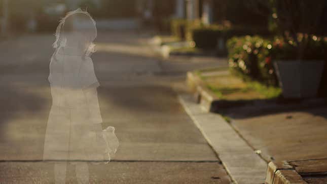 A photo of a suburban street with the ghostly, transparent outline of a young girl holding a teddy bear standing in the street